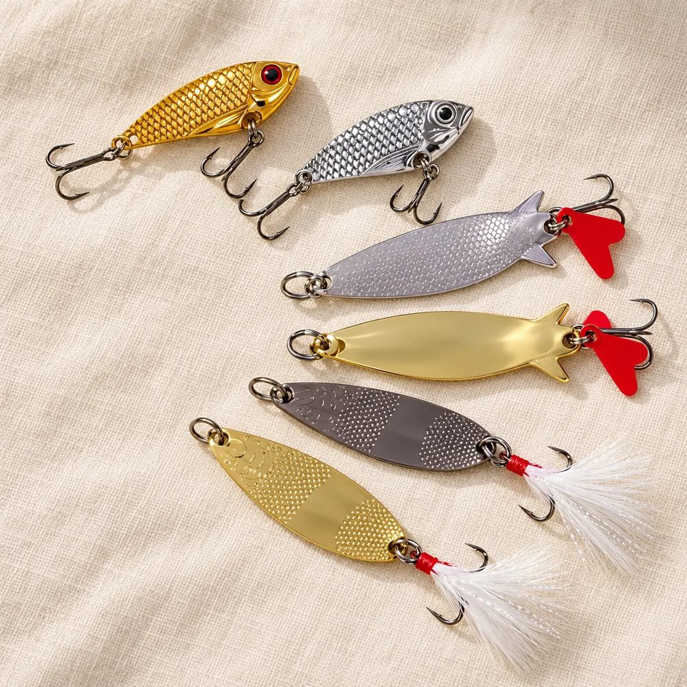 Six metal spoon lures fanned out on linen